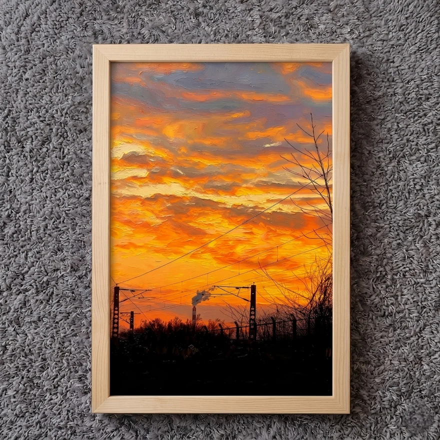 Framed painting illustration of a vivid orange sunset above silhouetted trees and railway wires; illustrative example